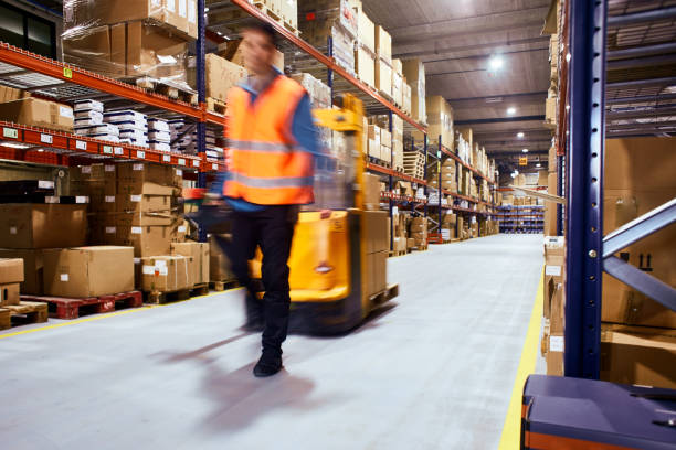warehouse, worker with a forklift in motion blur. - shipping supplies imagens e fotografias de stock