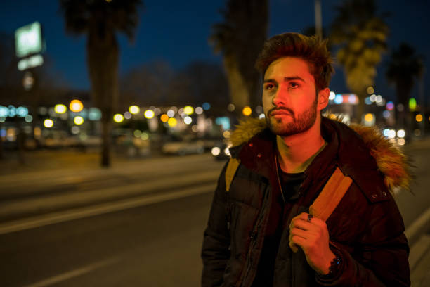 istock Cool young man crossing the street 1143020376