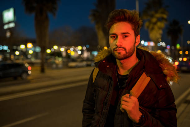 istock Cool young man crossing the street 1143020455