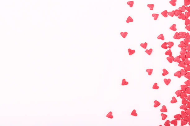 istock Pink heart shaped sprinkles on white background 1143020523