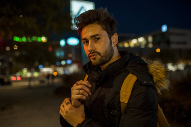 istock Cool young man crossing the street 1143021073