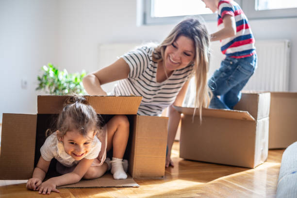 istock Happy siblings playing in boxes moving into new home 1143021600