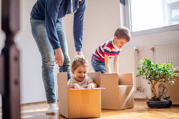 istock Happy siblings playing riding in box moving into new home 1143021763