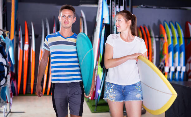 istock Couple is ready for surfing with board in time summer holidays 1143022167