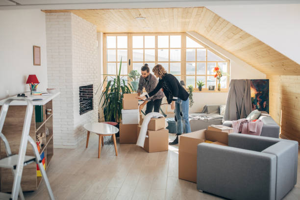 istock Boyfriend and girlfriend unpacking boxes in new home 1143022272