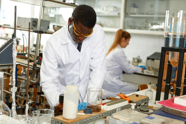 istock Man lab technician in glasses performing experiments and  writing results 1143022612