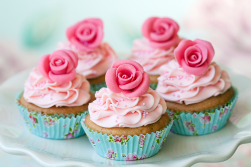 Birthday cupcakes on pink and blue background