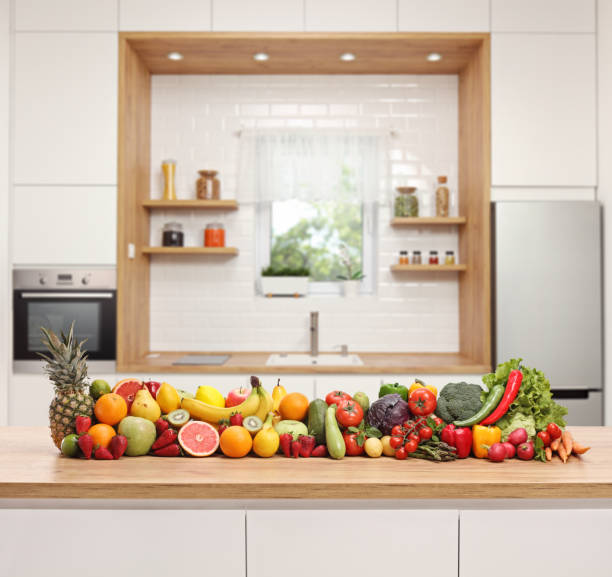 istock Fruits and vegetables placed on a wooden counter in a modern kitchen 1143026192