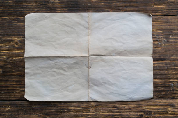 istock Blank sheet of old paper on a wooden table. 1143027268