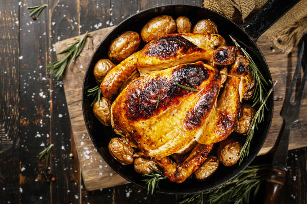 istock Baked whole chicken with spices on pan 1143029564
