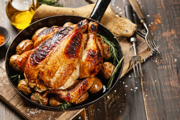 istock Baked whole chicken with spices on pan 1143029849