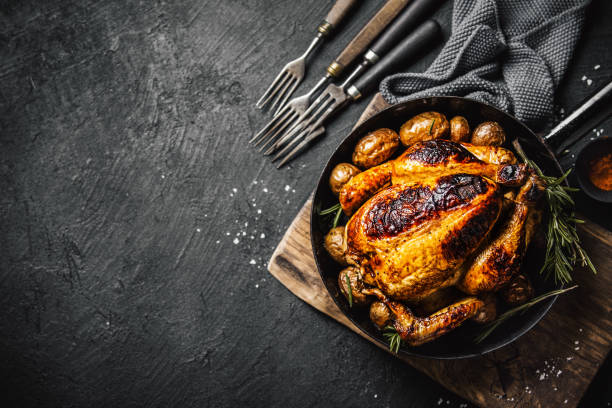 istock Baked whole chicken with spices on pan 1143029888