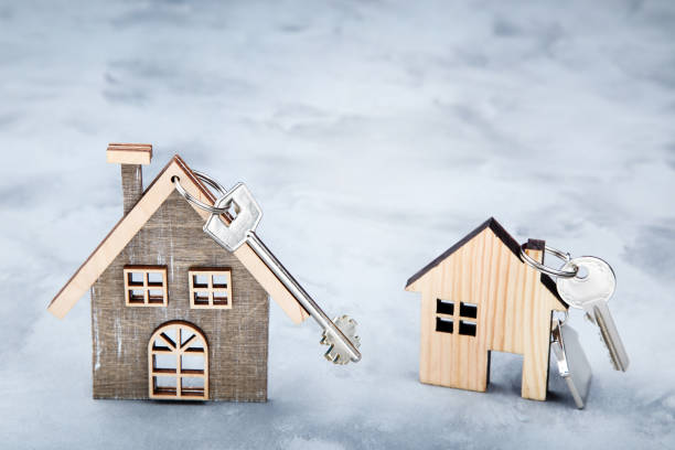 istock Silver keys with house symbol on gray background 1143030078