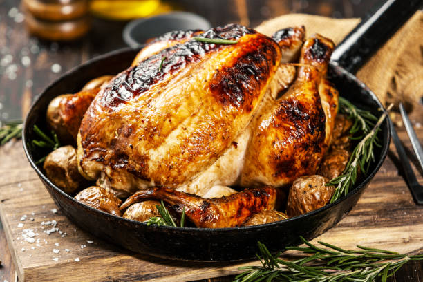 istock Baked whole chicken with spices on pan 1143030722