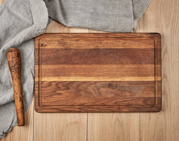 istock Empty old wooden kitchen cutting board and a gray towel 1143030841