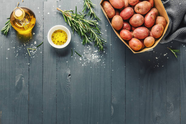 istock Raw organic potatoes with spices on wooden table 1143031241