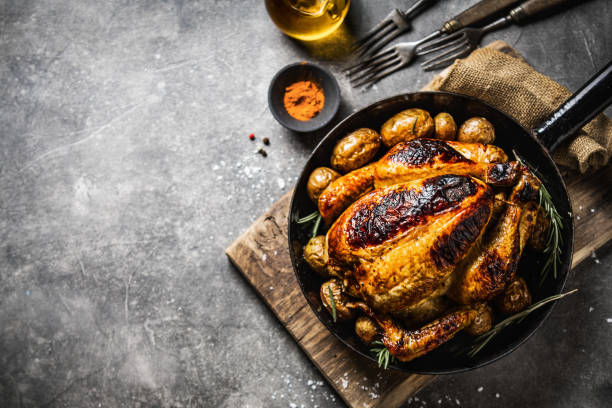 istock Baked whole chicken with spices on pan 1143031337