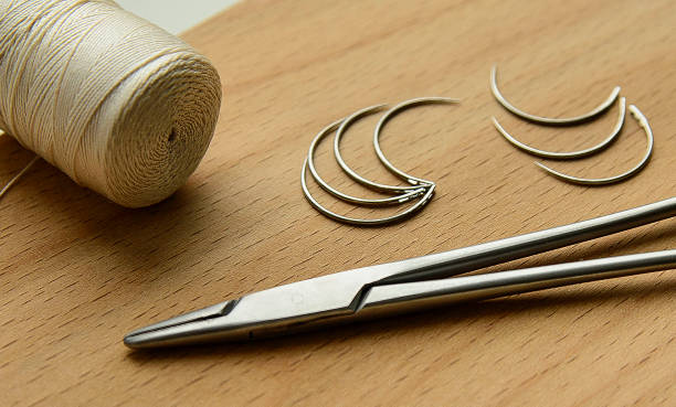 istock surgeon's suture instruments on wooden background 1143031562
