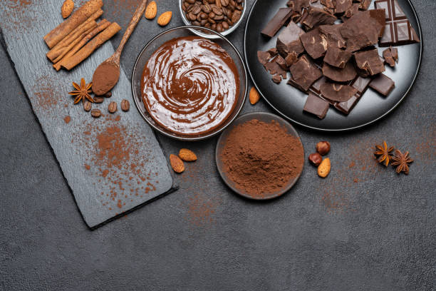 istock Melted chocolate or Hazelnut spread in glass bowl and chocolate pieces on dark concrete background 1143033457