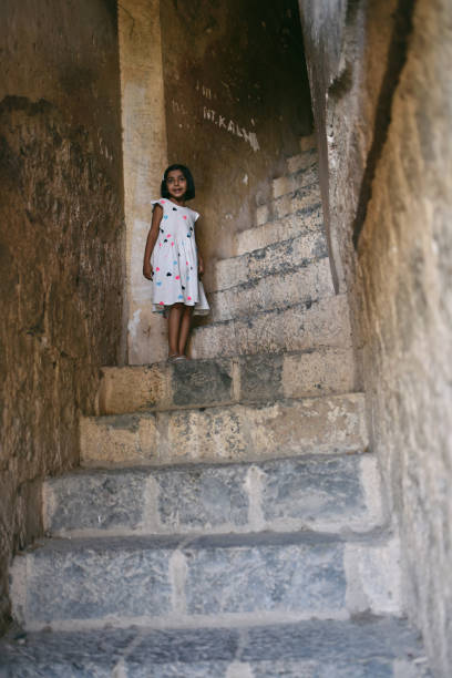 istock Young girl standing at staircases 1143034346