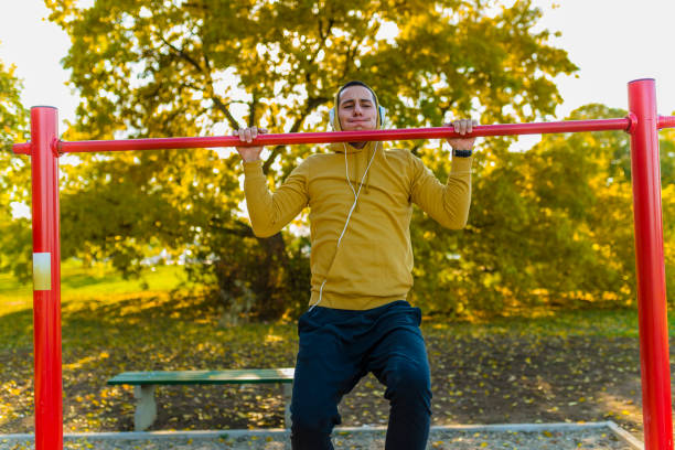 istock Young Muscular Male Athlete Doing Pull-Up Exercises In The Park 1143038325