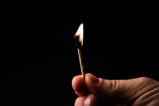 istock Isolated image of burning matche with flame od black background 1143038565
