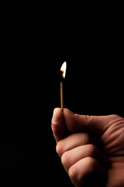 istock Isolated image of burning matche with flame od black background 1143039291