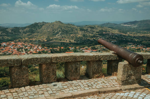 istock Old cannon overlooking hilly landscape in Monsanto 1143040751