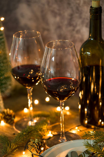 istock Red wine glasses with Christmas lights 1143040871