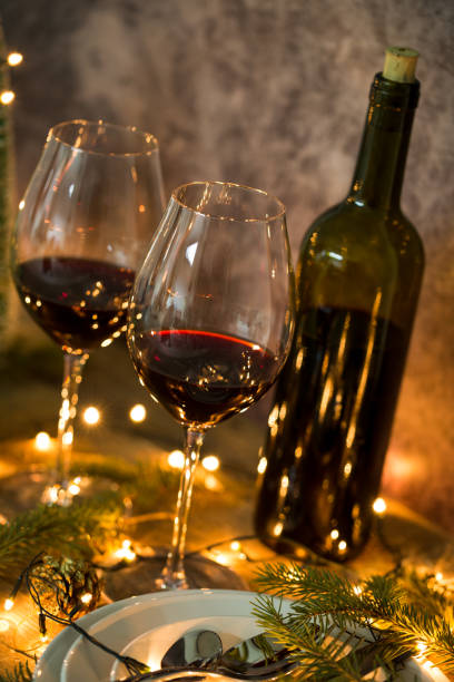 istock Red wine glasses with Christmas lights 1143041069