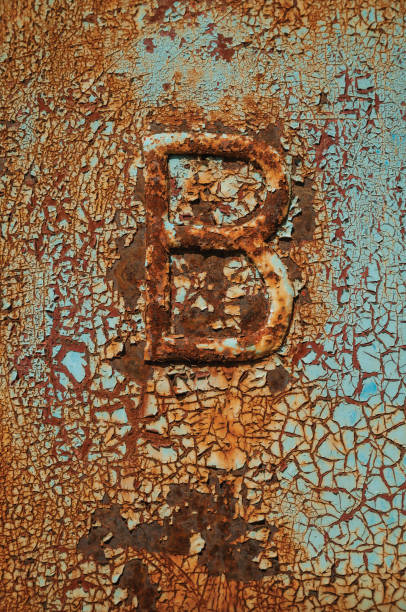 istock Rusted metal with cracks, peeling paint and the B letter 1143043194