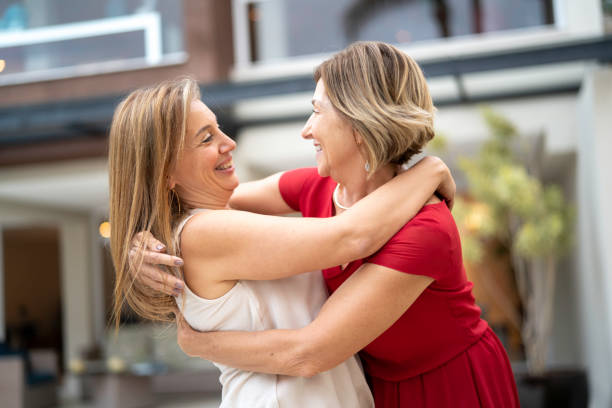 istock Mother and daughter embracing in front o house 1143043555