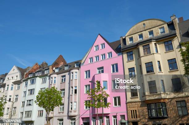 Pink Townhouse Between Other Houses Stock Photo - Download Image Now - House, Building Exterior, Individuality