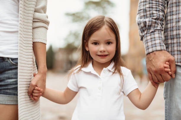 istock Cheerful kid walking with parents outside 1143045649