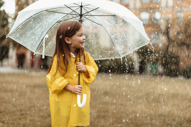 istock Happy kid holding umbrella outside 1143045672