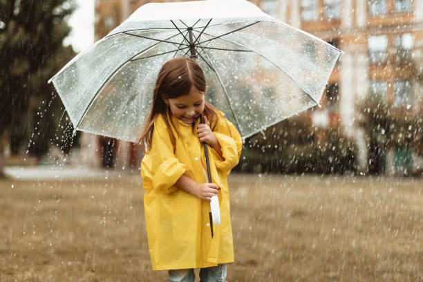 istock Joyful kid playing in rainy weather 1143045675