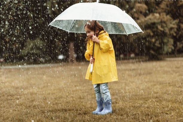 istock Happy kid playing outside on rainy day 1143045686