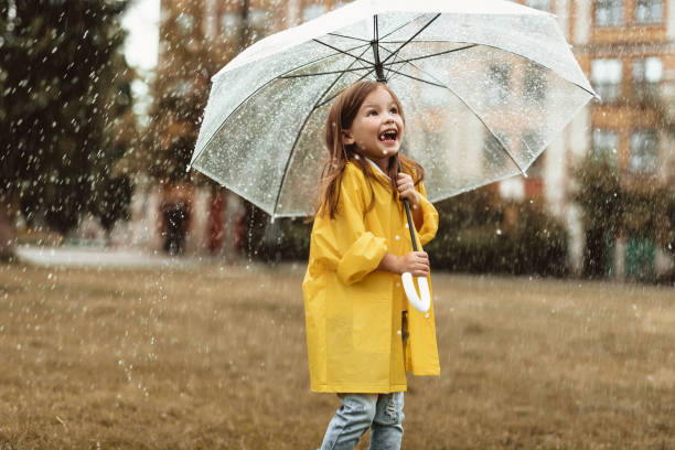 Excited child feeling happy about rainy weather