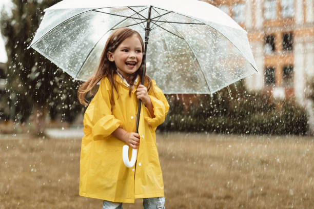 istock Blissful kid enjoying rain outside 1143045690