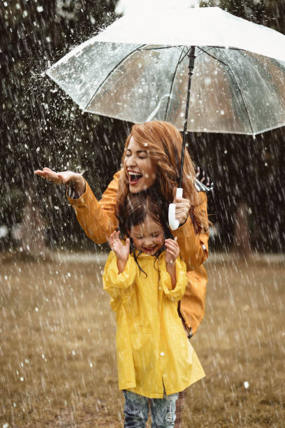 istock Excited mom and kid admiring rainy weather 1143045699