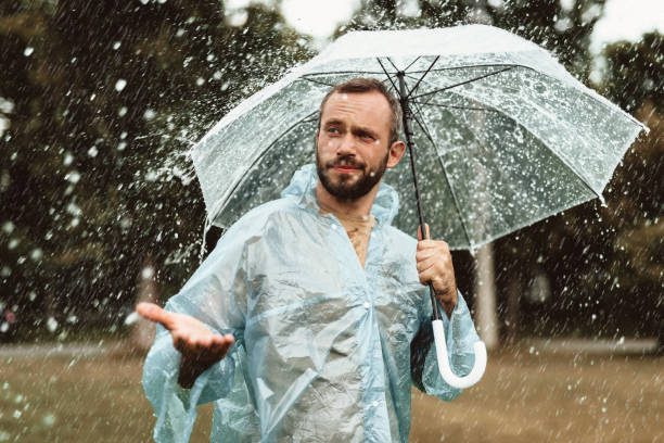 istock Happy male catching rain drops outside 1143045734