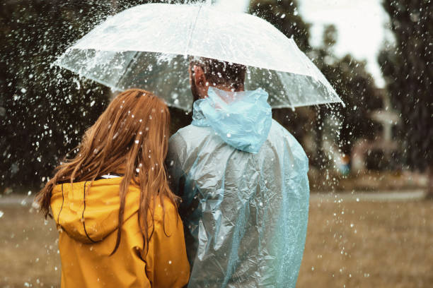 Man and woman walking in rain