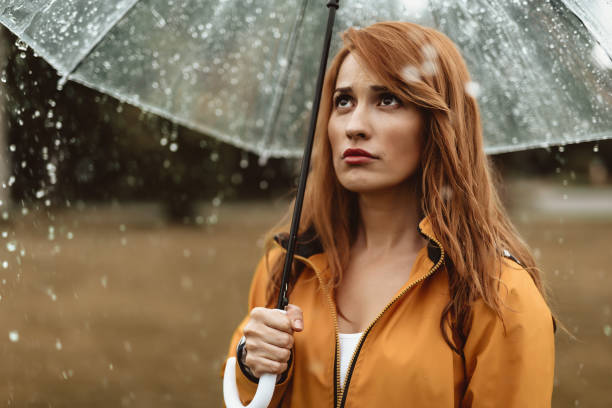 istock Attractive girl feeling sad about weather 1143045807