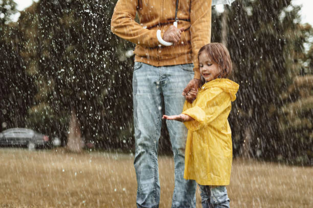 istock Little girl playing with rain drops 1143045848
