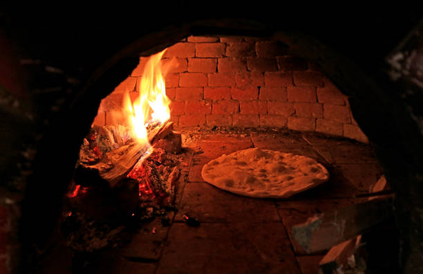 istock Pizza Dough Being Baked in the Wood Fired Pizza Oven 1143046073