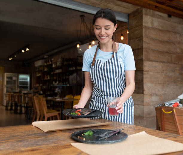 istock Waitress cleaning the tables at a restaurant 1143046074