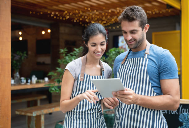 istock Waiters working at a restaurant and looking at the menu on a digital tablet 1143046145