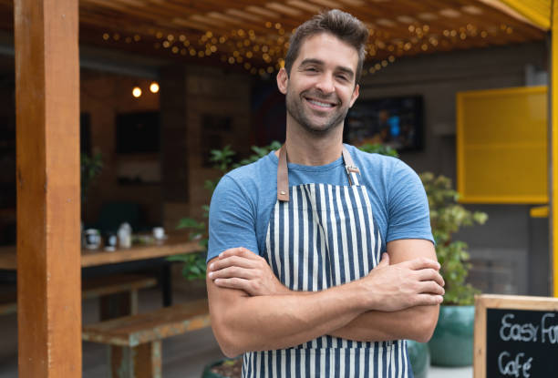 istock Happy waiter working at a cafe and smiling 1143046157