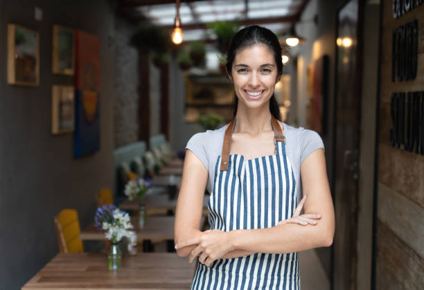 istock Happy business owner working at a restaurant holding a tablet computer 1143046158