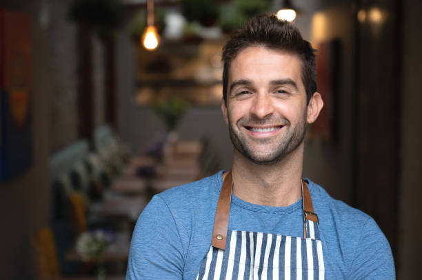 istock Happy waiter working at a cafe 1143046170